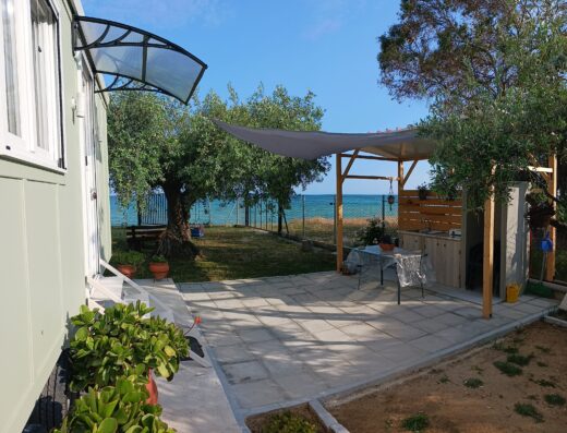 A mobile home with a patio and a view of the ocean.