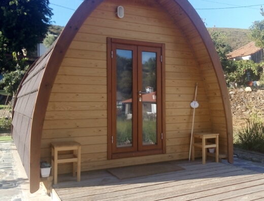 A wooden cabin sitting on a wooden deck.