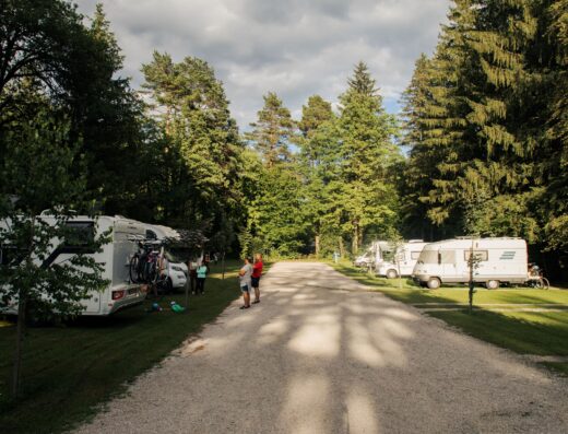 A group of rv's parked on a dirt road.
