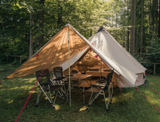 A tepee tent with a table and chairs.