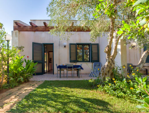 A small garden with a table and chairs.