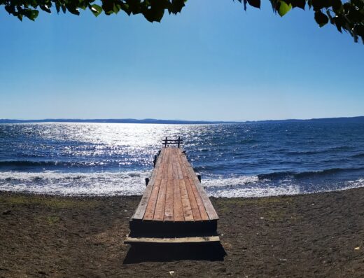 A fish eye view of a dock on a lake.