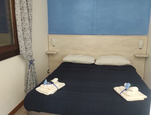A bed in a room with blue walls.