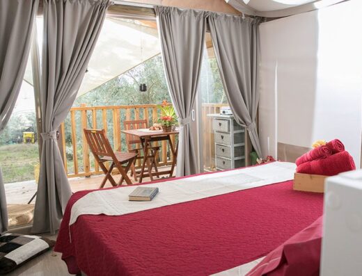 A bedroom with a bed and a window.