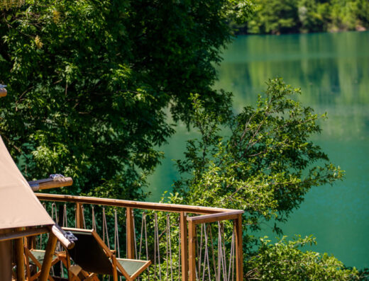 A wooden deck overlooking a lake.